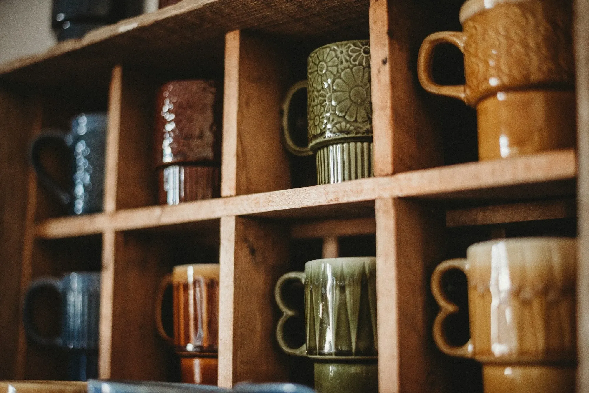 Coffee mug display in wooden cubbies